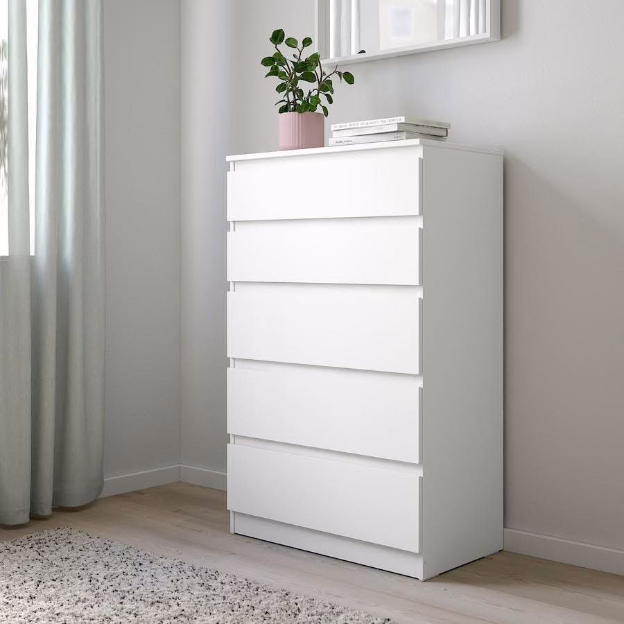 5 drawer Modern white 5-drawer chest of drawers placed in a bright minimalist bedroom corner with clean lines, spacious storage compartments, soft neutral décor, and decorative styling on top.